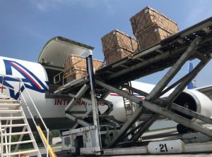 Cargo being loaded onto a Boeing 767 airplane utilizing a main deck loader