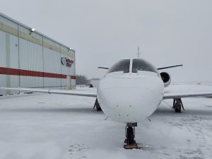 Plane parked outside Grand Aire hangar