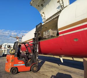 Cargo being loaded onto an airplane by a forklift