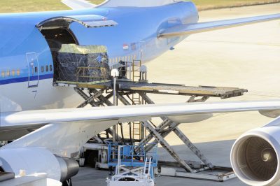 Freight being loaded onto a cargo airplane through the side cargo door